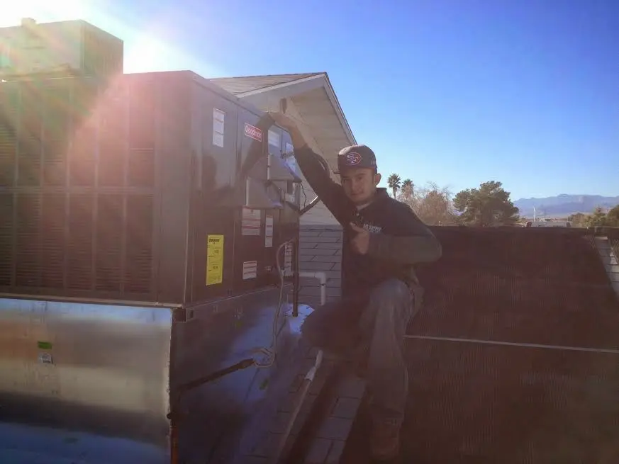 HVAC technician performing Air Duct Repair on a rooftop unit in Temple City